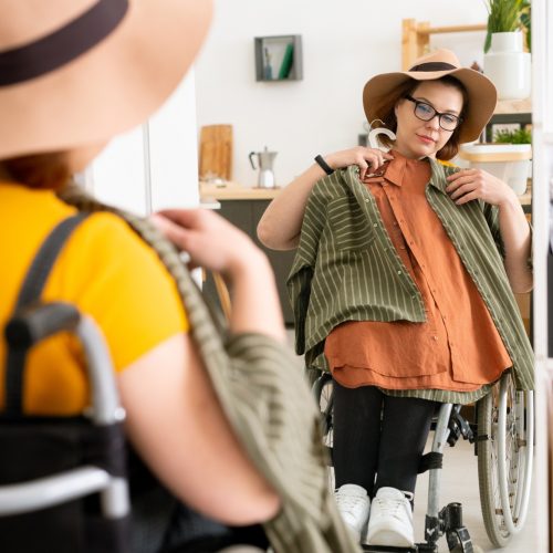 Disabled woman trying on clothes before walk